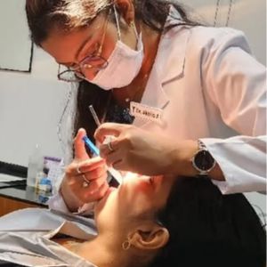 Dr Akhila Treating a Patient at Vallamattam Dental Clinic Kakkanad